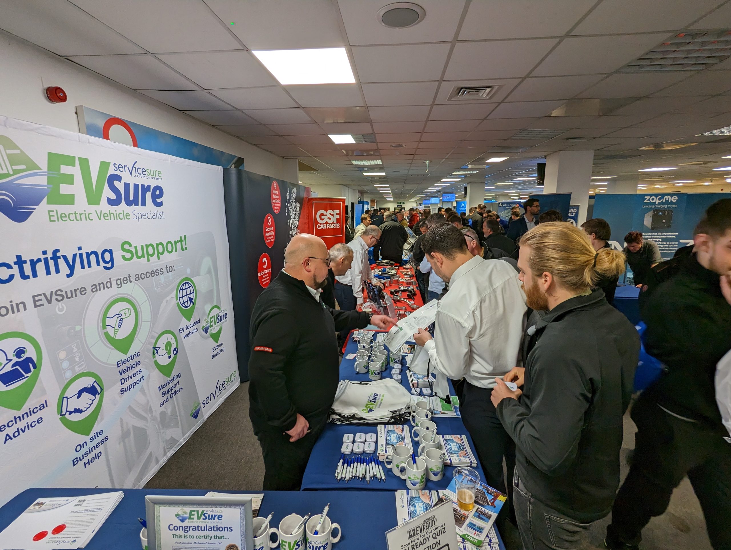 EV Ready attendees visit Servicesure’s EVsure stand and GSF Car Parts’ product exhibition stand